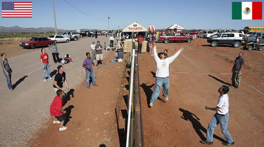 Residents Of Naco, Arizona And Naco, Mexico Play Volleyball Match Over Fence Between USA And Mexico