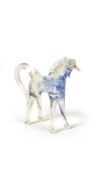 Object: A glass horse The caption (abridged): I took a trip to Venice. I was admiring an artist who was making beautiful sculptures in glass. In front of us he was sculpting a beautiful horse. I said: Oh, I would be very happy if I had it. Then we returned to the city. It was a long walk back to our hotel. We didn’t talk a lot, but it was a peaceful time which both of us enjoyed. I was very happy. Just before we reached the hotel my husband kissed me on the cheek and gave me a small package. He said: Darling, I love you. I’ll never stop loving you. You are my life. I answered: Me too, dear. When we entered the room, I opened my gift and saw the little glass horse. 20 years later, I am divorced. His love disappeared like the wind. I put the glass horse into the box beside the wedding ring and shut it. I say to myself: Don’t cry! Tomorrow is a new day.